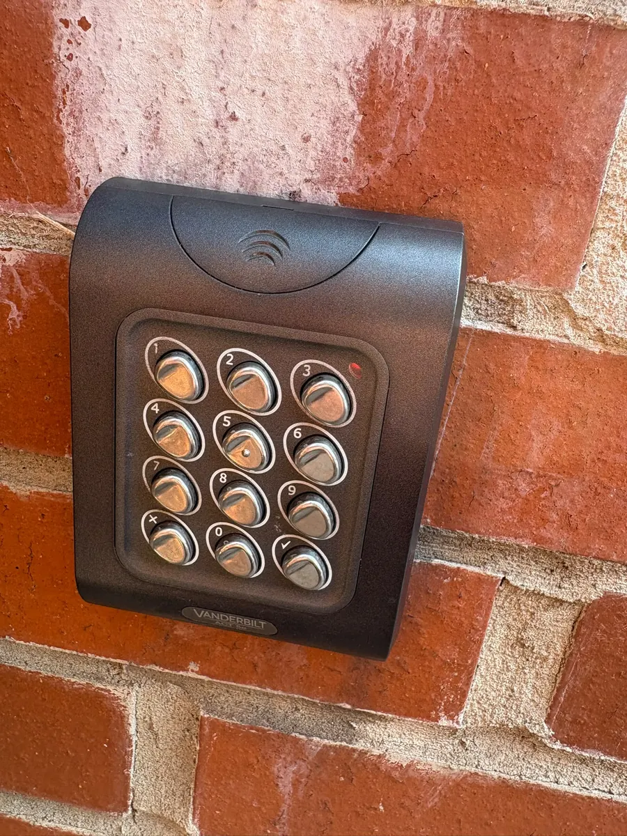 A digital access keypad mounted on an outside wall.