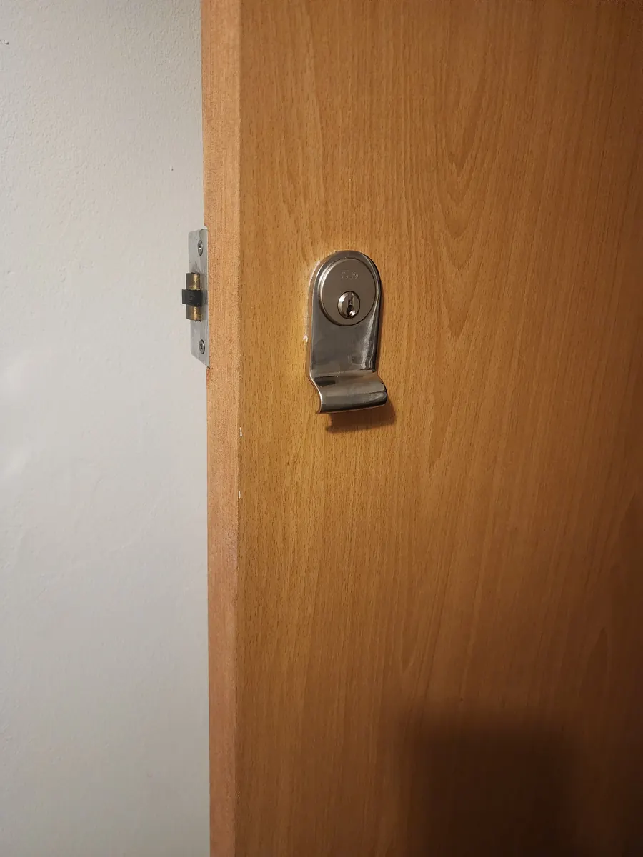 Bathroom thumbturn lock on an internal door.