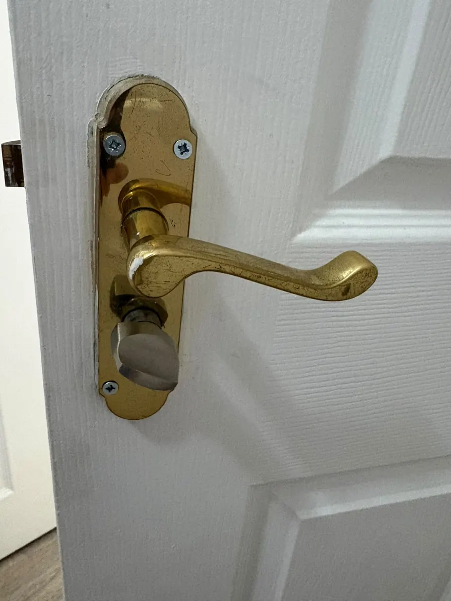 Brass lever handle with a bathroom turn.