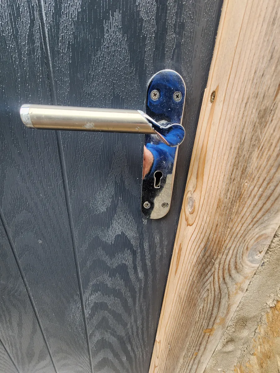 Before: the lever handle on a composite front door has snapped at the spindle.