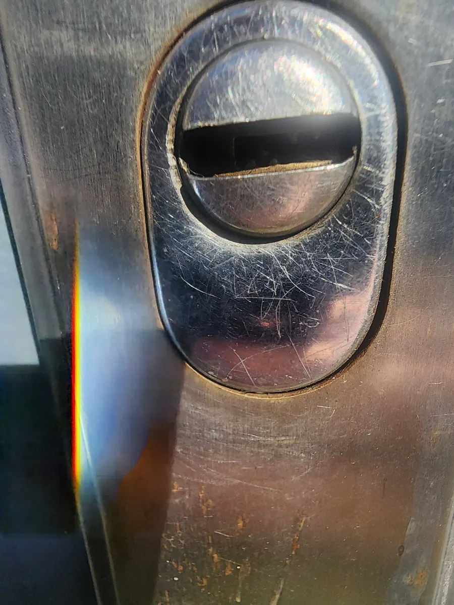 Security escutcheon protecting a cylinder lock.