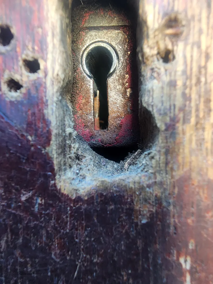 Lock case exposed after the timber around it was broken away.