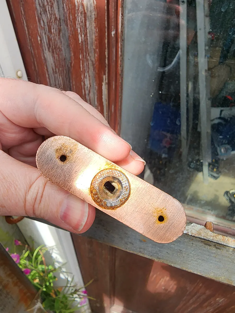 A worn hasp removed from a gate.