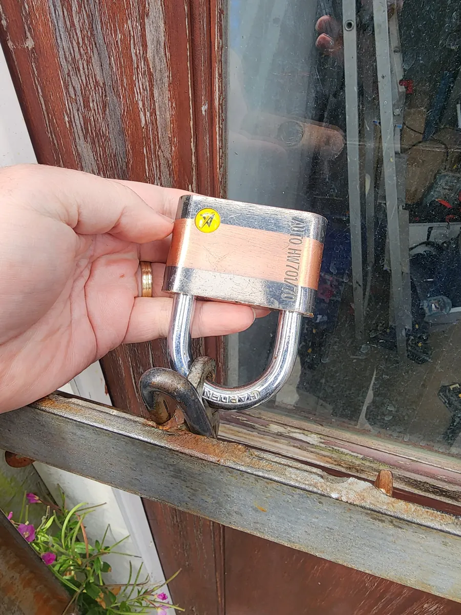 A heavy-duty padlock on a gate.