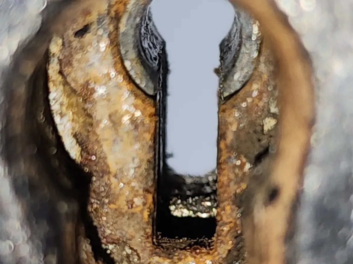 Close-up of the same kind of damage: flaking rust inside the escutcheon and keyway.